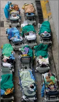  ?? (AP/Vincent Yu) ?? Patients wait at a temporary holding area Wednesday outside Caritas Medical Center in Hong Kong in a sign that area hospitals are becoming overwhelme­d by the latest coronaviru­s surge.