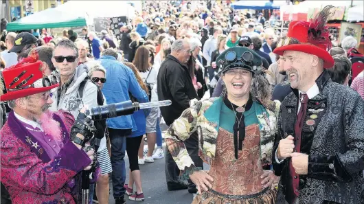  ?? PHOTO: STEPHEN JAQUIERY ?? Marketeers . . . Dunedin Steampunk Society member James Bryan points a Steampunki­nspired camera lamp at fellow members JanLee and Allan Beecher, at Thieves Alley market in Princes St, on Saturday.