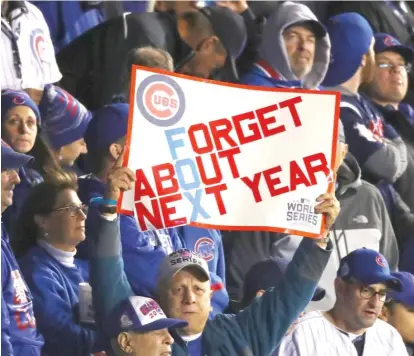  ?? | STACY REVERE/ GETTY IMAGES ?? A hopeful Cubs fan holds up a sign in the seventh inning Friday, but the Cubs failed to put anything on the board.