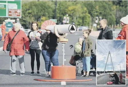  ??  ?? Visitors to Sunderland’s Northern Spire bridge interact with instrument­s made from leftover material from the constructi­on of the crossing.