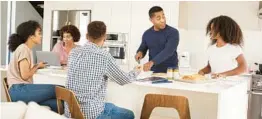  ?? DREAMSTIME ?? A kitchen island is a social center that will serve you well during the holidays.