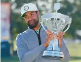  ?? MICHAEL WYKE/AP ?? Tony Finau holds up the trophy after winning the Houston Open on Sunday. It was the 33-year-old Finau’s fifth career PGA Tour title and third this year.