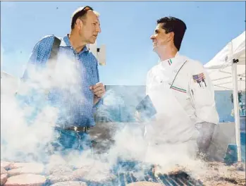  ?? Wally Skalij Los Angeles Times ?? STEVE DAYAN, left, who is running for secretary-treasurer of Teamsters Local 399, speaks with union member and chef Ruben Enriquez during filming of “House of Lies” in downtown Los Angeles last month.