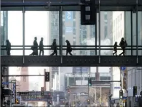  ?? JIM MONE — THE ASSOCIATED PRESS FILE ?? The climate-controlled skyway system in Minneapoli­s provides warmth for people moving from building to building. Visitors in town for the Super Bowl may want to avail themselves of the skyway system as they navigate the city in winter.