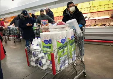  ?? REUTERS ?? A man wears a protective mask while shopping at BJ’S Wholesale Club market at the Palisades Center shopping mall during the coronaviru­s outbreak in West Nyack, New York, on Saturday.