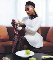  ?? Justin J Wee For The Times ?? JANELLE MONÁE removes white paint from fruit in reference to the short film linked to her 2018 album “Dirty Computer.” With the book “The Memory Librarian,” Monáe expands the album’s world.