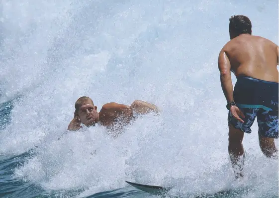  ?? Picture: JOHN MULHEARN/@CRYSTAL_CYLINDER ?? Three-time world surfing champion Mick Fanning was kicking back with a mate at Greenmount Beach.