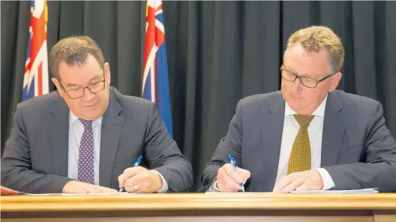  ?? Photo / Mark Mitchell ?? Finance Minister Grant Robertson and Reserve Bank Governor Adrian Orr sign the Policy Targets Agreement, but is it time to re-write the rules of fiscal policy?