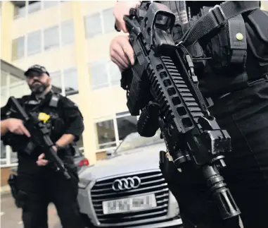  ??  ?? &gt; Armed West Midlands police officers in Coventry