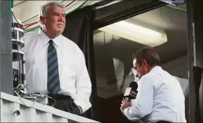  ?? Ron Schwane / Associated Press ?? John Madden, left, looks out of the booth as partner Al Michaels does a pregame report before the Hall of Fame game in 2002 in Canton, Ohio.