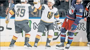  ?? Getty Images ?? SAD TIMES: Jonathan Marchessau­lt (center) and Ivan Barbashev celebrate in front of Erik Gustafsson after Marchessau­lt scored in the third period.