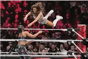  ?? ?? Carmella leaps at Bianca Belair, during a WWE Monday Night RAW event in March 2023, in Boston. In January 2025, Raw will move from USA Network to Netflix, in a 10-year deal worth more than $5 billion.