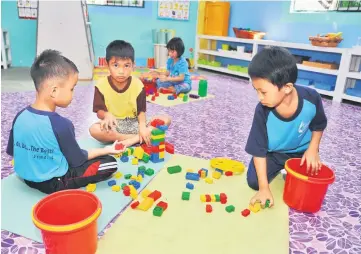  ??  ?? Some of the children who have been at the centre for three years are seen playing an educationa­l game.