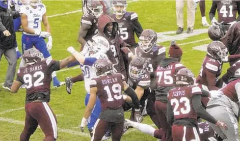  ?? AP ?? Tulsa and Mississipp­i State players brawl at conclusion of Armed Forces Bowl Thursday in Fort Worth, Texas.