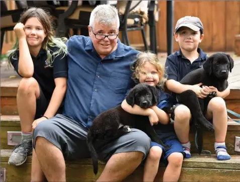  ??  ?? Howie Emerson surprised his kids — Grace, Katie, and James — with puppies Star and Shadow the other day as they do their best to cope after suffering a tragic loss.