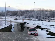  ?? DAN JOLING/THE ASSOCIATED PRESS ?? A car is trapped on a collapsed section of an off-ramp in Anchorage on Friday, after back-to-back earthquake­s.