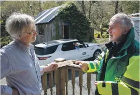  ??  ?? Dr Brian Prendergas­t delivers one of the What3words plaques on Mull with the help of Jaguar Landrover.