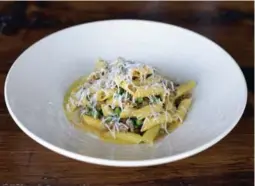  ??  ?? Hand-rolled garganelli pasta at Campo is surrounded by fresh juicy pork sausage chunks and green peas ($18). On top is a flurry of parmesan.