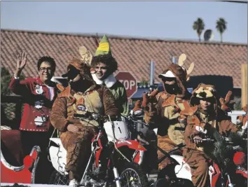  ?? IVP FILE PHOTO ?? El Centro City Councilmem­ber Sylvia Marroquin and her entourage ride passed Wells Fargo bank on Main Street for the 75th annual El Centro Christmas Parade, Dec. 4, 2021.