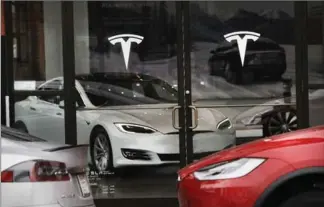  ?? GETTY IMAGES FILE PHOTO ?? Tesla electric vehicles are displayed in a showroom at the company’s dealership in Brooklyn, N.Y.