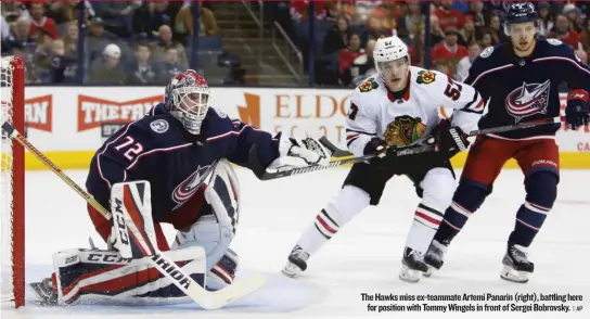  ??  ?? The Hawks miss ex- teammate Artemi Panarin ( right), battling here for position with Tommy Wingels in front of Sergei Bobrovsky. | AP