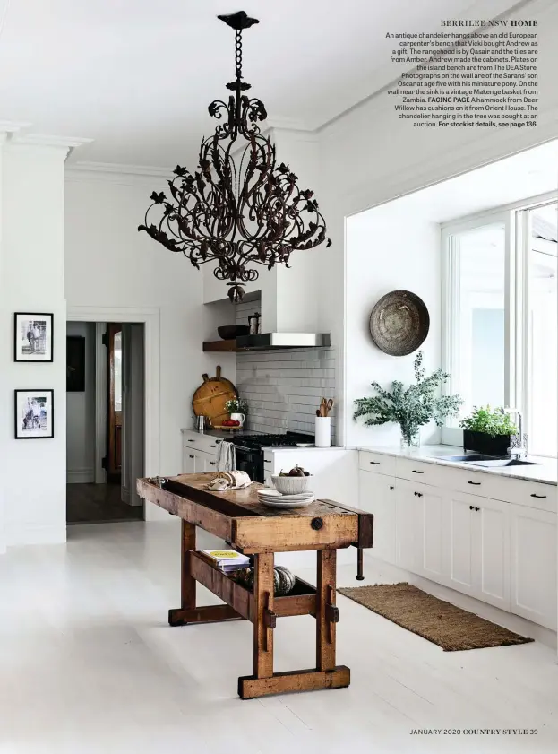  ??  ?? BERRILEE NSW HOME
An antique chandelier hangs above an old European carpenter’s bench that Vicki bought Andrew as a gift. The rangehood is by Qasair and the tiles are from Amber. Andrew made the cabinets. Plates on the island bench are from The DEA Store. Photograph­s on the wall are of the Sarans’ son Oscar at age five with his miniature pony. On the wall near the sink is a vintage Makenge basket from Zambia. FACING PAGE A hammock from Deer Willow has cushions on it from Orient House. The chandelier hanging in the tree was bought at an auction. For stockist details, see page 136.