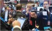  ?? — Reuters ?? Traders work on the floor of the New York Stock Exchange (NYSE) in New York.