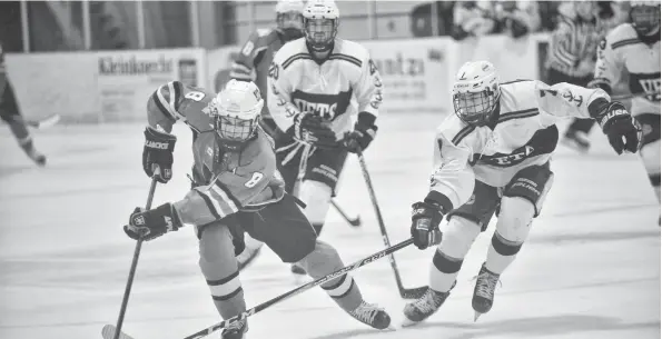  ?? [VERONICA REINER / THE OBSERVER] ?? Wellesley’s Austin Cousineau struggles to keep control of the puck against a Woodstock Navy Vet during Sunday's matinee, a 6-5 overtime loss.