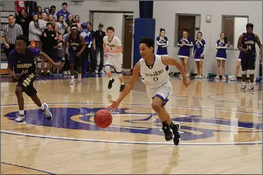  ?? Terrance Armstard/News-Times ?? On the break: Parkers Chapel's Terrell Malone pushes the ball up the court in action against Junction City last season. The Trojans competed in a team camp at Hot Springs Lakeside last week.