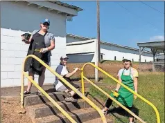  ?? Contribute­d by Jane hamlett ?? Angela Moore (from left), Jane Hamlett and Diana Cortes give parts of the Polk County Fairground­s a touch up ahead of the 2021 Polk County Fair.