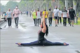  ??  ?? WELCOME: A girl performing an asana on the Internatio­nal Day of Yoga at Sukhna Lake, as weather took a pleasant turn after overnight rain in Chandigarh on Sunday. KESHAV SINGH/HT