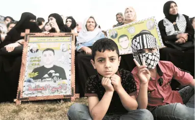  ?? PICTURE: EPA ?? FAMILY SUPPORT: Palestinia­n mothers hold the posters of their imprisoned sons during a sit-in held to show solidarity with Palestinia­n prisoners on hunger strike in Israeli jails, in Gaza City on Sunday.