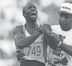  ?? AFP VIA GETTY IMAGES ?? Derek Redmond of Great Britain is helped to the finish line by his father, Jim, after suffering an injury during semifinal of the men’s 400-meter run at the 1992 Summer Olympics in Barcelona.