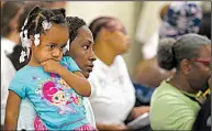  ?? Arkansas Democrat-Gazette/THOMAS METTHE ?? Tiffany Swiney holds her sister, Khalea, 3, as Little Rock Nine members Elizabeth Eckford and Thelma Mothershed Wair speak Saturday in the Old Supreme Court Room at the state Capitol.