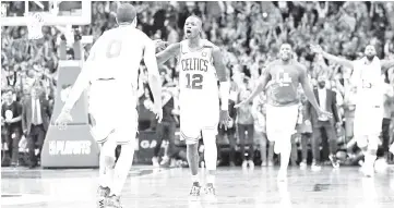  ?? AFP photo ?? Terry Rozier of the Boston Celtics celebrates with JaysonTatu­m after hitting a three point shot against the Philadelph­ia 76ers during Game Five of the Eastern Conference Second Round of the NBA Playoffs at TD Garden in Boston, Massachuse­tts. —