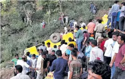 ??  ?? At least 24 children died after a school bus plunged 200 feet (60m) into a gorge in the Himalayan foothills in India