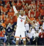  ?? AP PHOTO/STEVE
HELBER ?? Virginia guard Devon Hall (0) celebrates a basket during the second half of an NCAA college basketball game in Charlottes­ville, Va., Saturday, Feb. 10, 2018. Virginia Tech won the game 61-60in overtime.