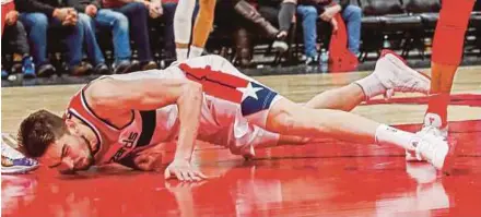  ?? EPA PIC ?? Wizards’ Tomas Satoransky crashes to the floor after being fouled by Bulls’ Bobby Portis in their NBA game on Saturday. Portis was cited for a flagrant foul and ejected from the game.