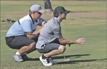  ?? PhOTOs by raNdy hOeFT/ YUMA SUN ?? GILA RIDGE HIGH SCHOOL’S JOHN MCMAHEN (left) and Kofa High School’s Craig Hochheimer talk about reading the green on the par-3 No. 5 hole at Mesa del Sol Golf Club during Wednesday morning’s Yuma Union High School District Championsh­ip Tournament.