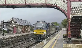  ?? KEN LARKINS ?? Not all RHTT workings are allocated to older traction – this one arrived at Settle on October 6, powered by Nos. 88002 Prometheus/68033 The Poppy, although the ‘88’ had failed and could not be restarted. The following 2H95/17.57 Carlisle to Leeds was stuck behind and left Settle 145 minutes late.