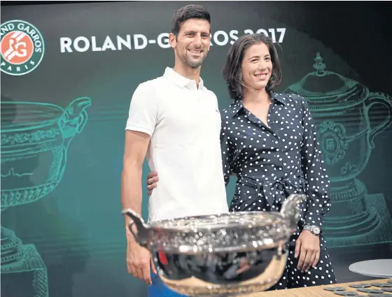  ??  ?? Defending champions Novak Djokovic, left, and Garbine Muguruza pose for a photograph during the draw.