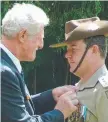  ?? Captain Anthony Gilchrist is presented with a US Bronze Star medal by former Charters Towers mayor Brian Beveridge. ??