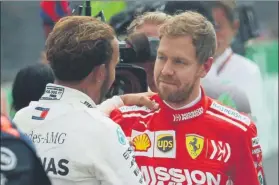  ??  ?? Deportivid­ad. Al acabar la carrera Sebastian Vettel felicitó a Lewis Hamilton por el título FOTO: AP