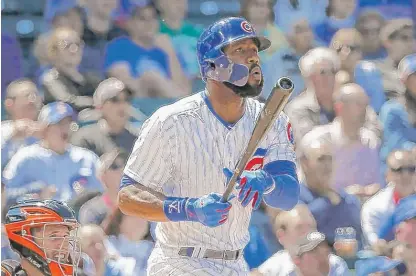  ??  ?? Jason Heyward watches his fifth homer of the season leave the park in the fifth inning Thursday at Wrigley Field. | CHARLES REX ARBOGAST/ AP