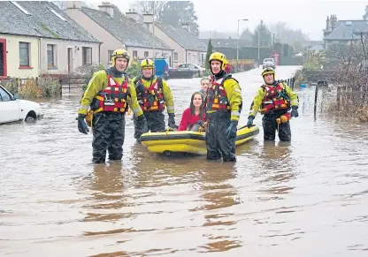  ??  ?? In at the deep end . . . firefighte­rs evacuate residents from houses on Glebe Road, Comrie, in 2012.