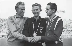  ?? Photo / Getty Images ?? New Zealand track star Murray Halberg (centre) on top of the podium in Rome after winning the 5000m in 1960.