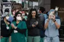  ?? Photograph: Braulio Jatar/ Sopa Images/Rex/Shuttersto­ck ?? Firefighte­rs applaud medical workers outside of a Manhattan hospital to show gratitude for their great work in the fight against Covid-19.