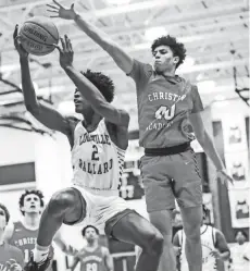  ?? MATT STONE/COURIER JOURNAL ?? Christian Academy of Louisville's George Washington, seen here playing defense, has several college visits planned, including one to Ohio State.