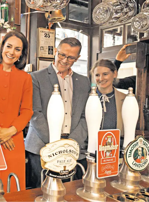  ?? ?? The Prince and Princess of Wales at the Dog and Duck pub in Soho, London. The Prince pulls the first pint of Kingmaker, a Coronation special pale ale