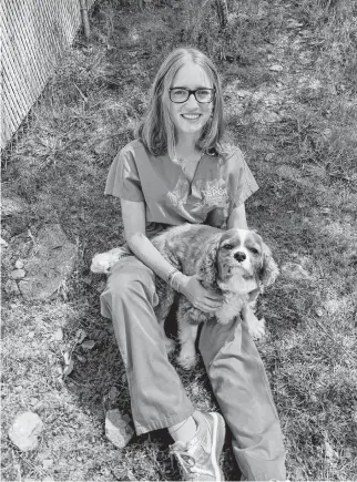  ??  ?? Cassidy Beson with eight-year-old Chester, a cavalier king Charles spaniel that’s at the SPCA in Nova Scotia.